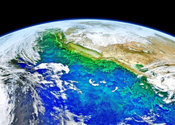 Uma vista da Terra vista do espaço, mostrando águas oceânicas vibrantes em tons de azul, verde e turquesa, nuvens rodopiantes e massas de terra com montanhas cobertas de neve — um planeta belo, porém frágil, frequentemente no centro da ecoansiedade. A escuridão do espaço forma o fundo. | YogaLounge